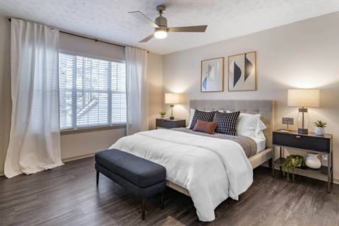 a bedroom with a white bed and a window